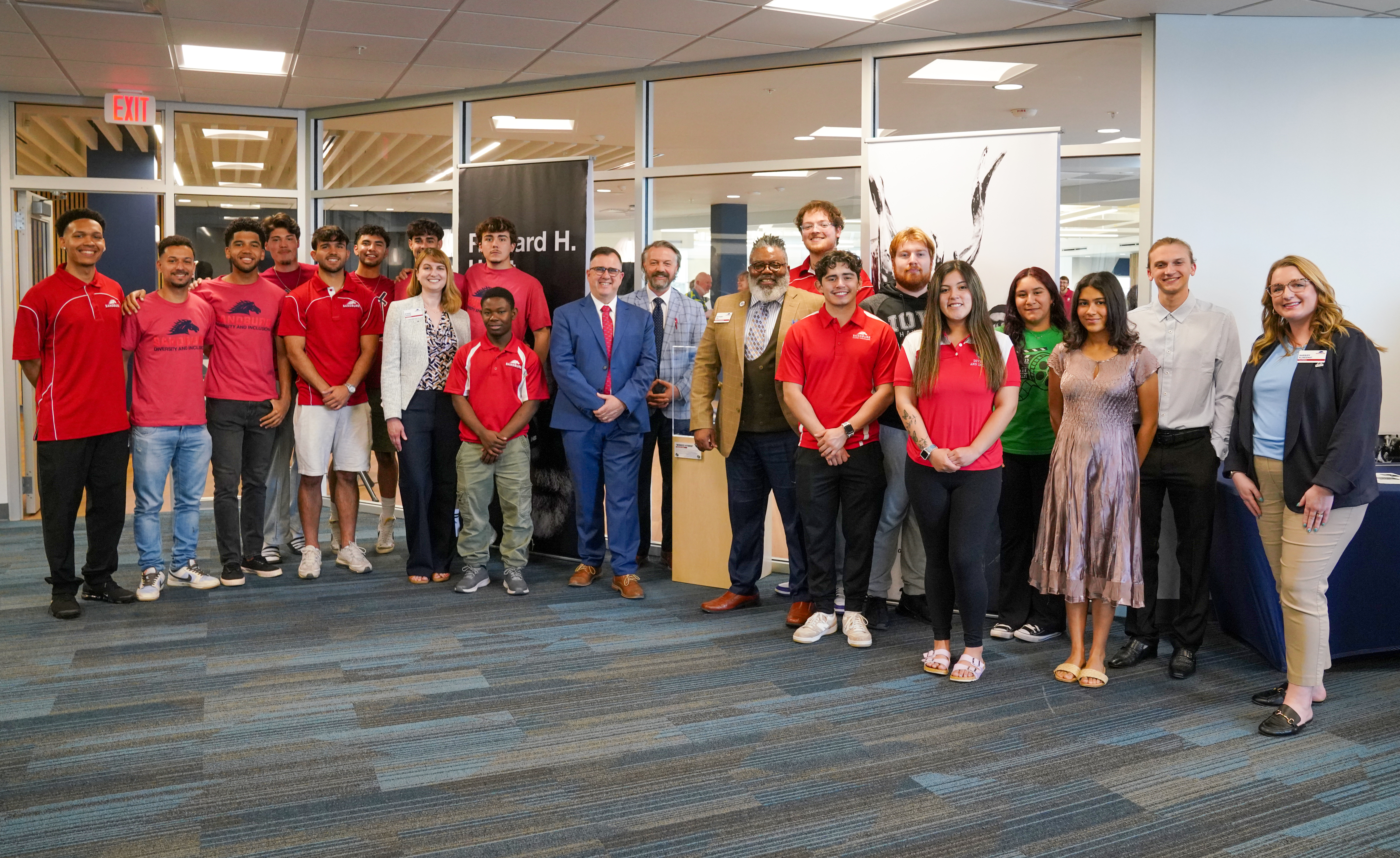 Sandburg students, faculty and staff stand near the display case for Richard Hunt's "Winged Hybrid" at Thursday's dedication ceremony in the Student Center.