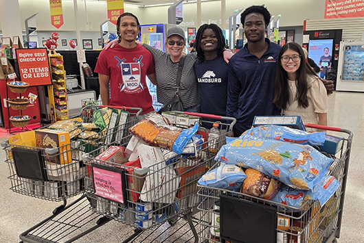 Students in Hy-Vee with grocery carts