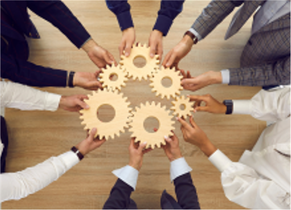 a group of hands placing gears in a circle