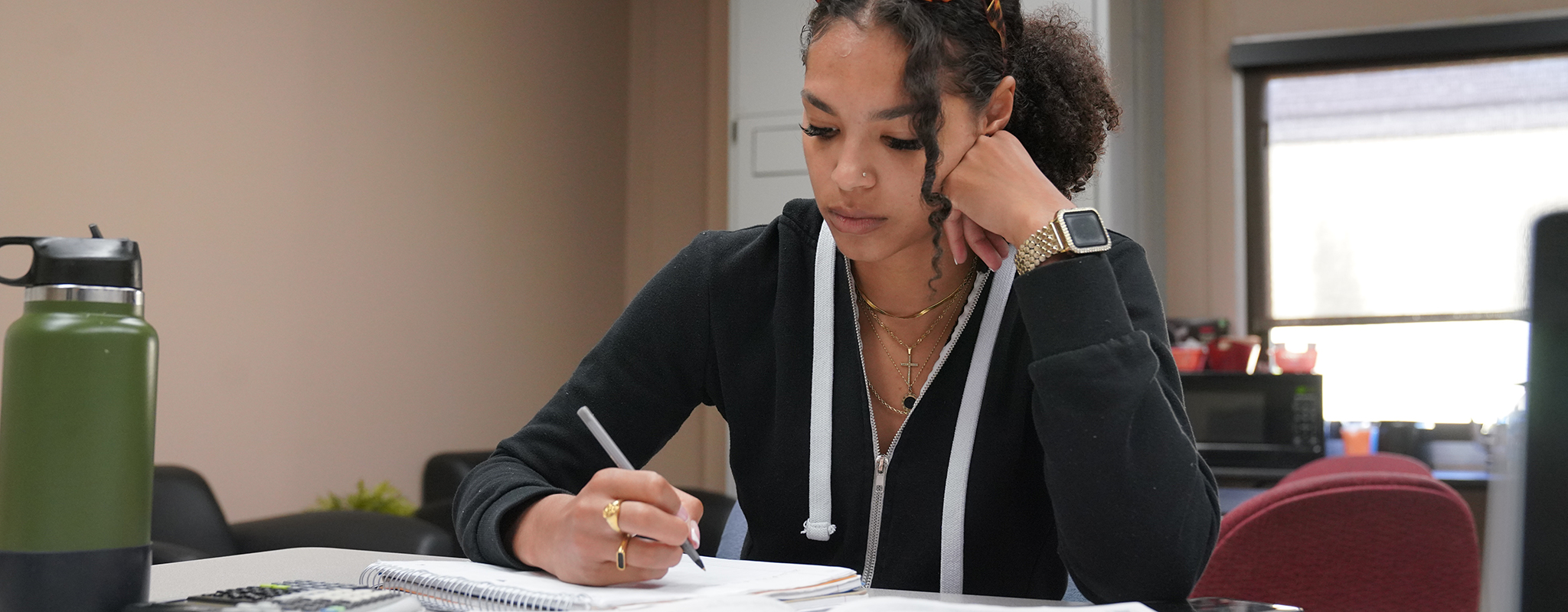 Female student doing their homework in the tutoring center.