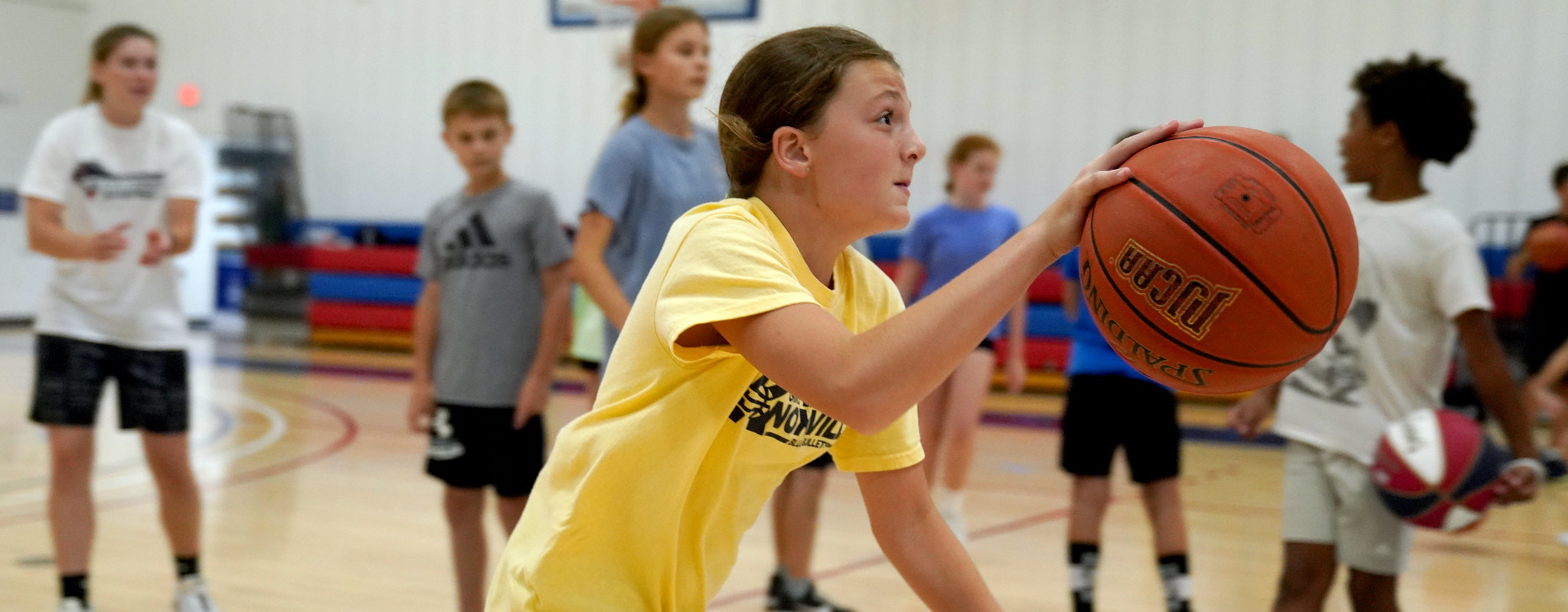 girl dribbling a basketball.