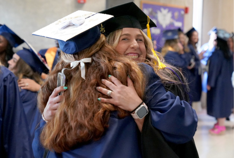 Two Sandburg graduates hugging