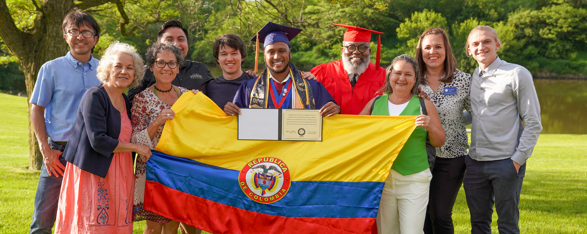 International student at graduation posing with family.