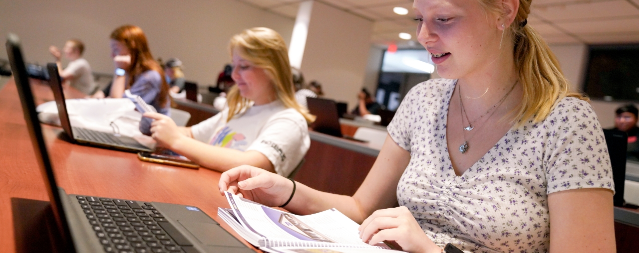 student sitting in a lecture hall.