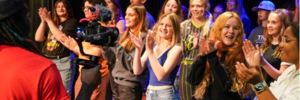 a group of students clapping