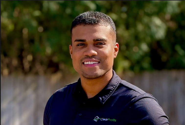 Man in polo shirt standing.