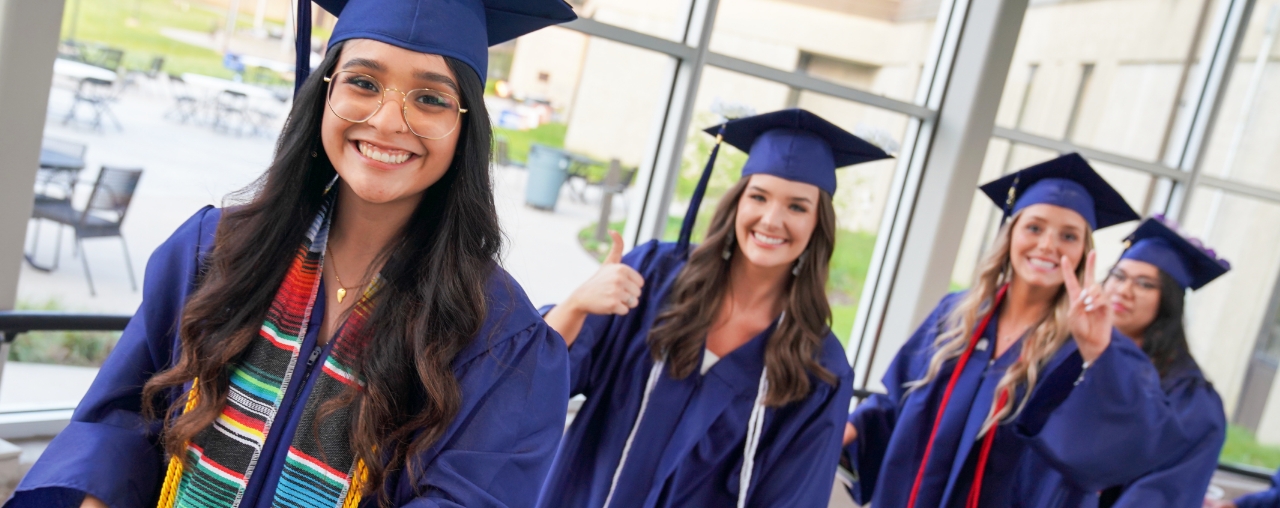 students in cap and gown at graduation.