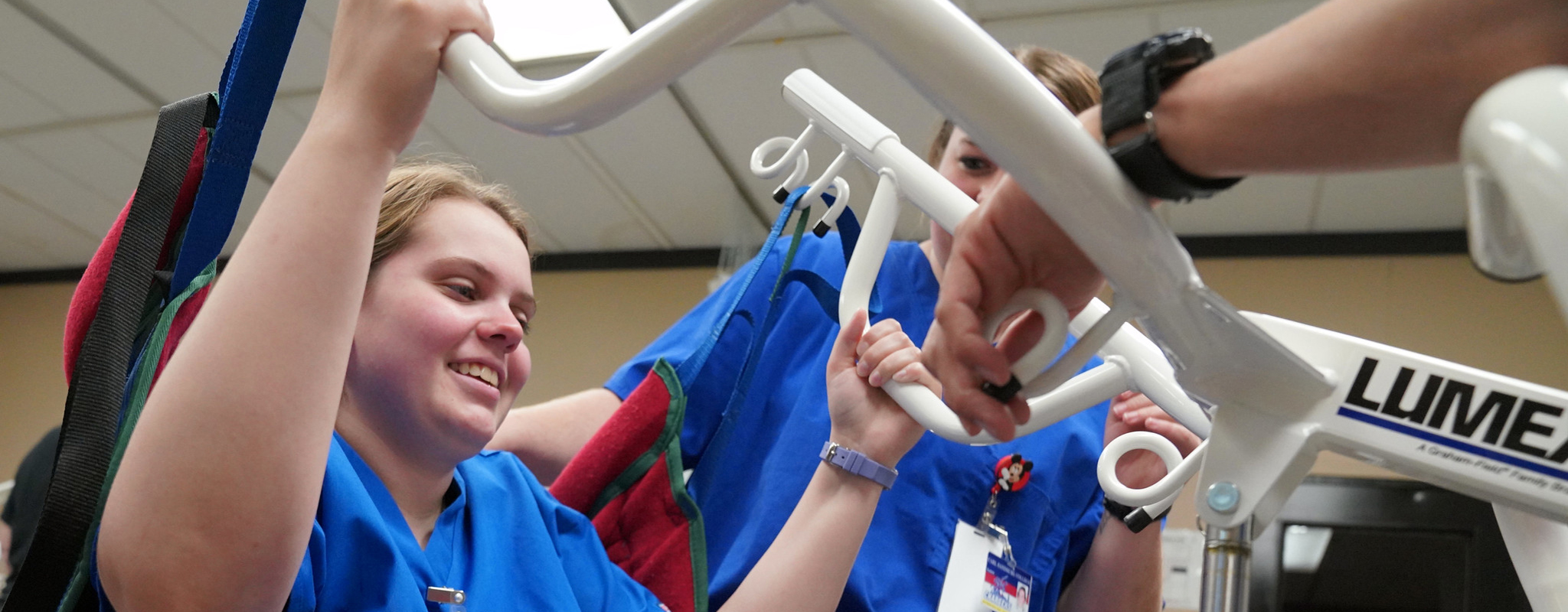 CNA student using a body lift in class.