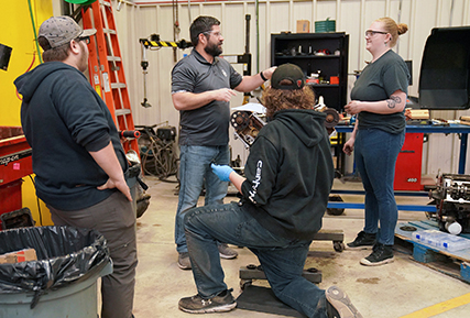 auto instructor talking to student in the auto bay.