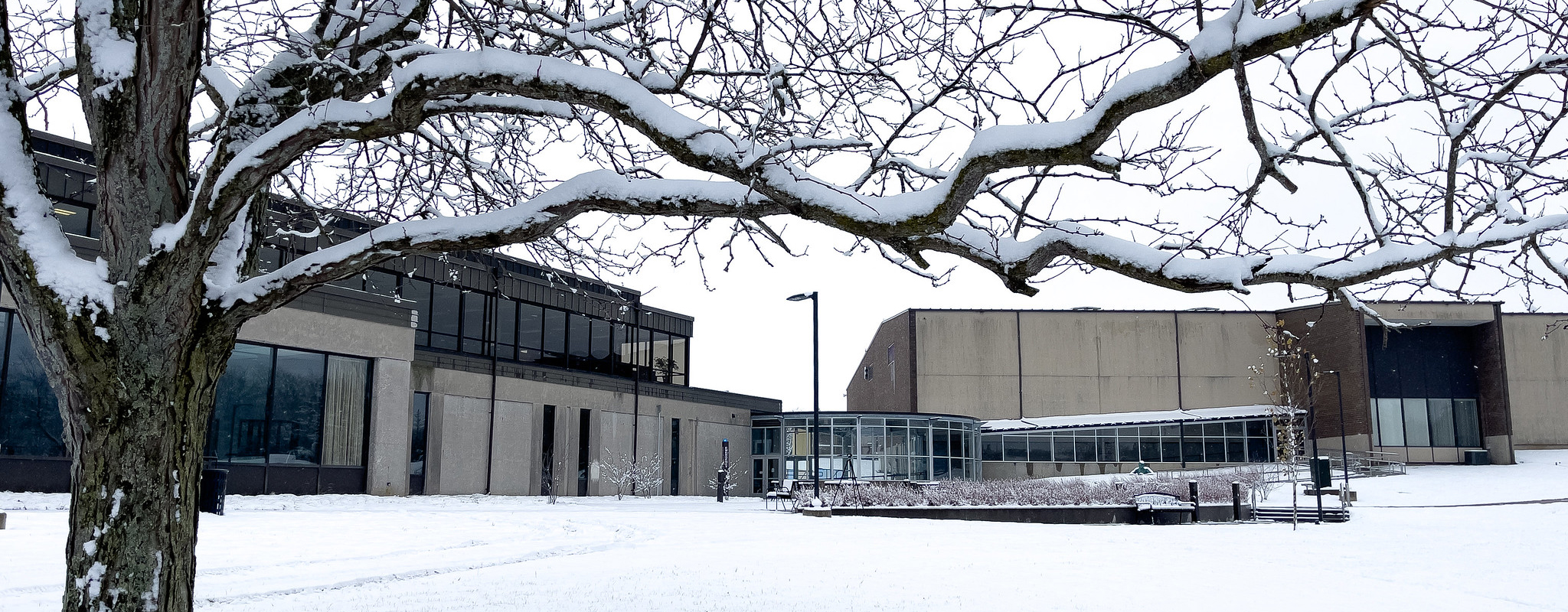 A campus building covered in snow.