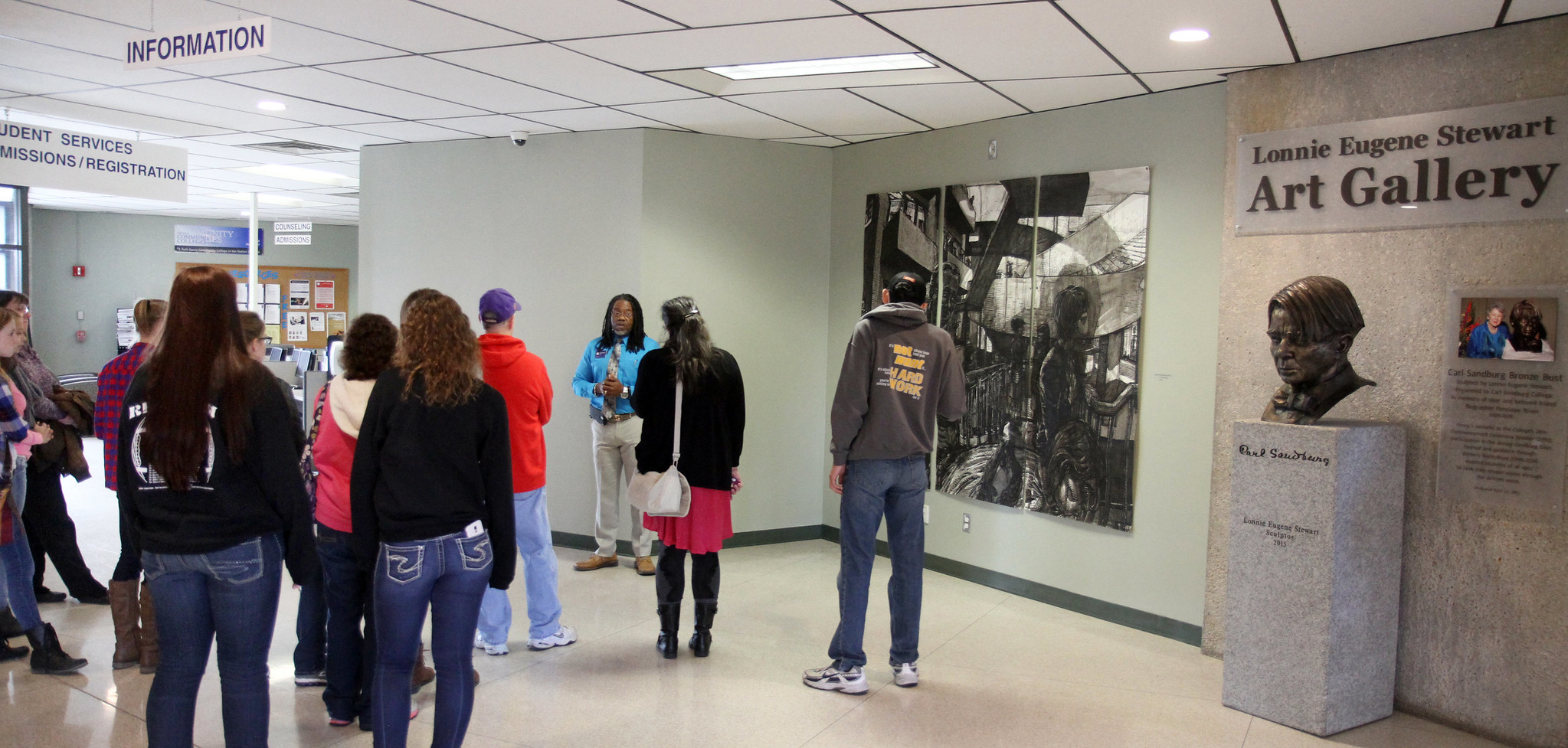 students on a campus tour, located in the art gallery.