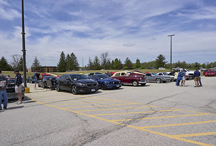 A parking lot with many nice cars.