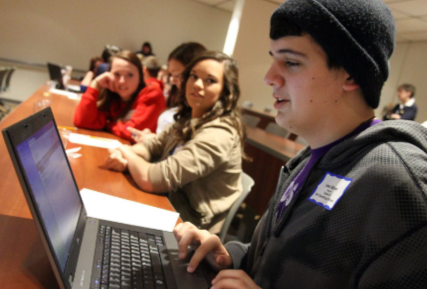 Sandburg students working on laptops in a classroom