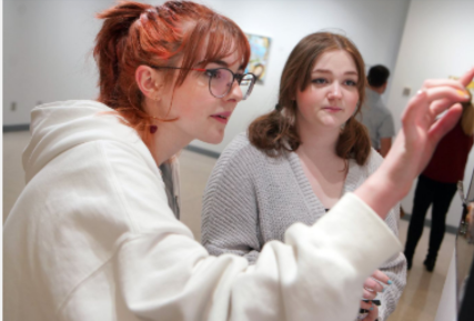 Two Sandburg students looking at art