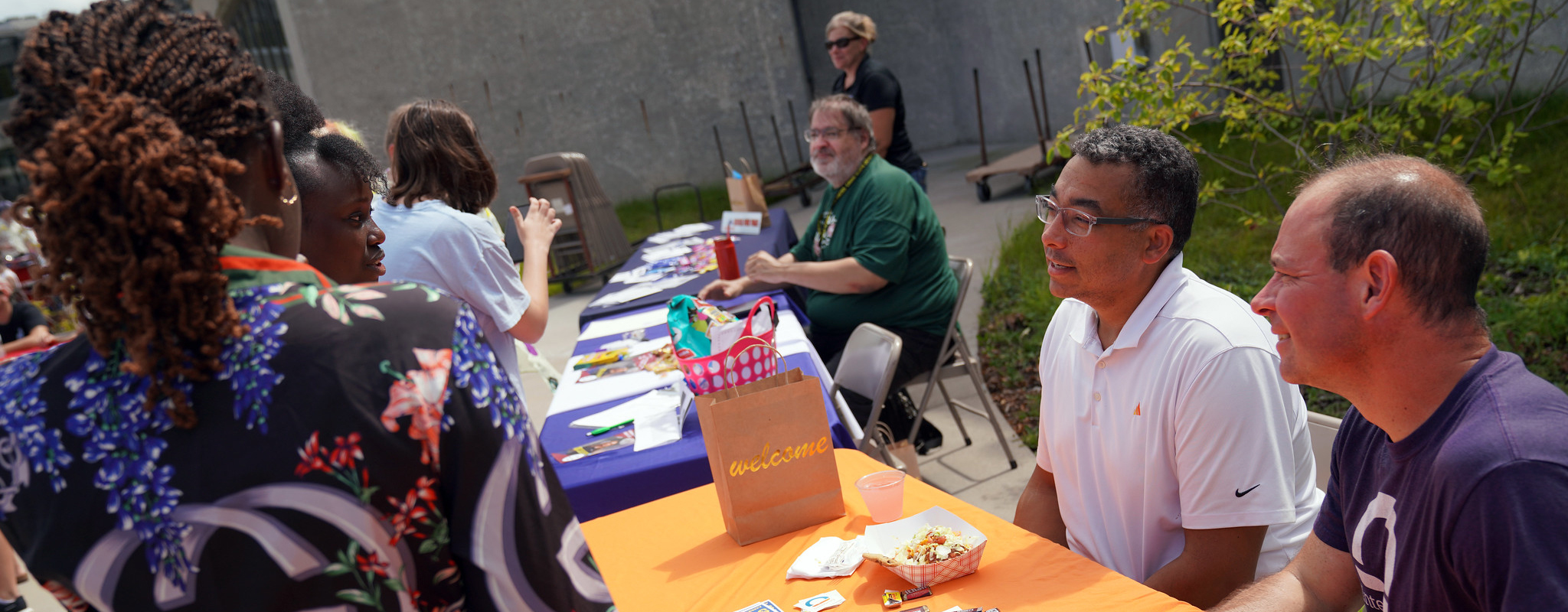 Students talking at info tables.