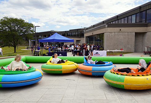 Students riding bumper cars during fall fest.