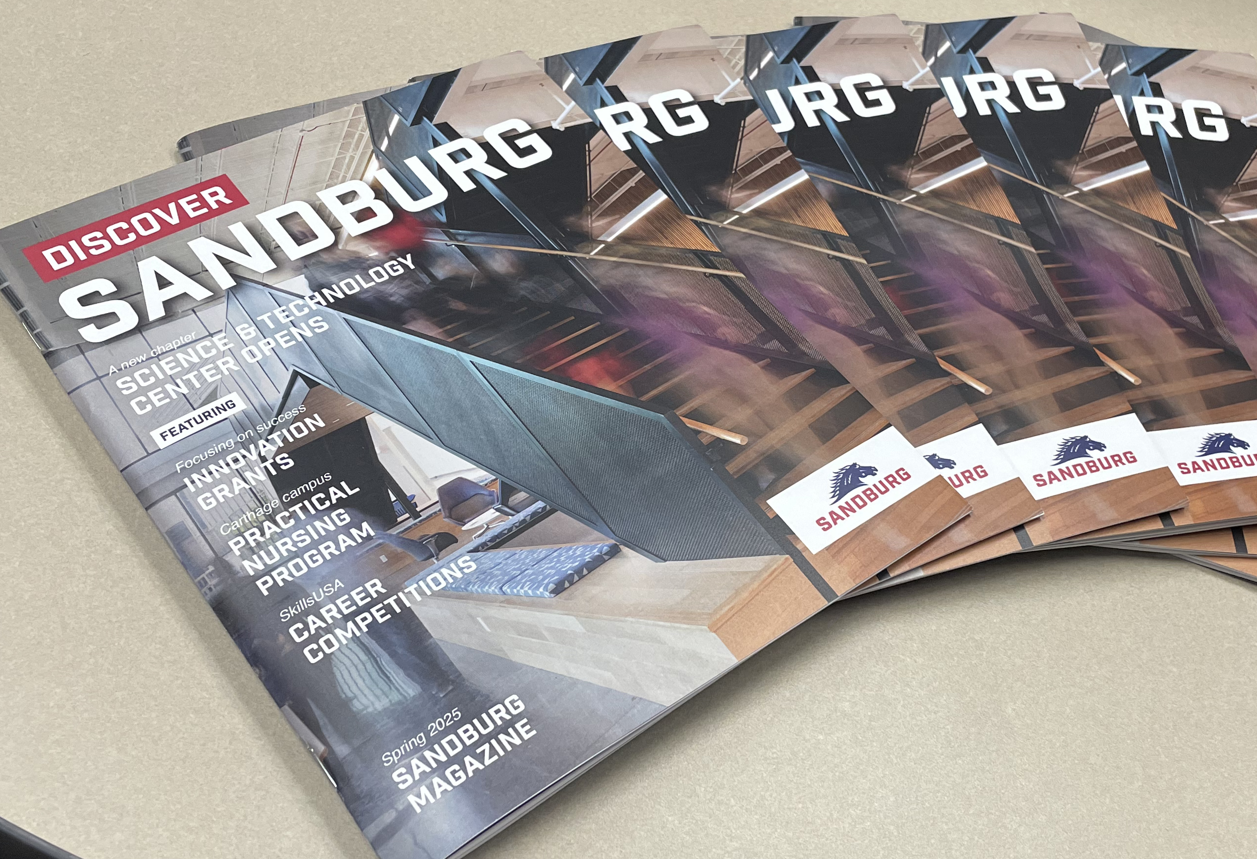 Sandburg magazines fanned on a table.
