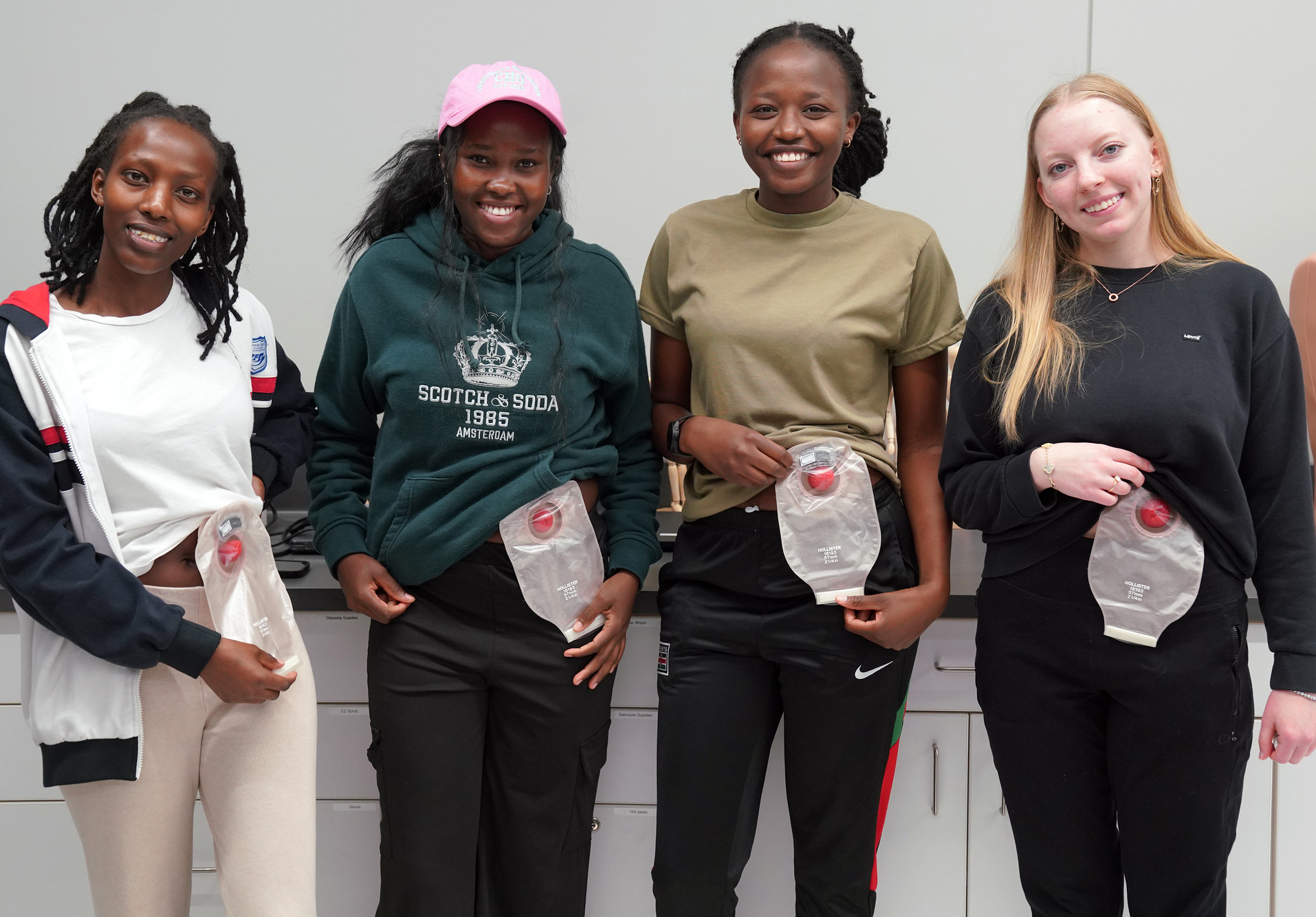Nursing students with ostomy pouches