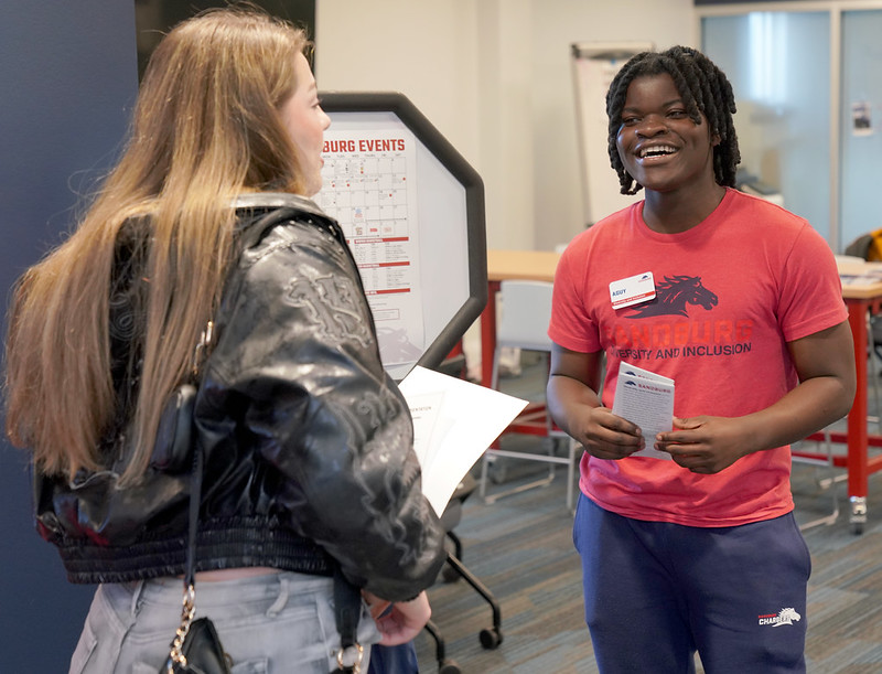 Sandburg student ambassador assisting new student at orientation.