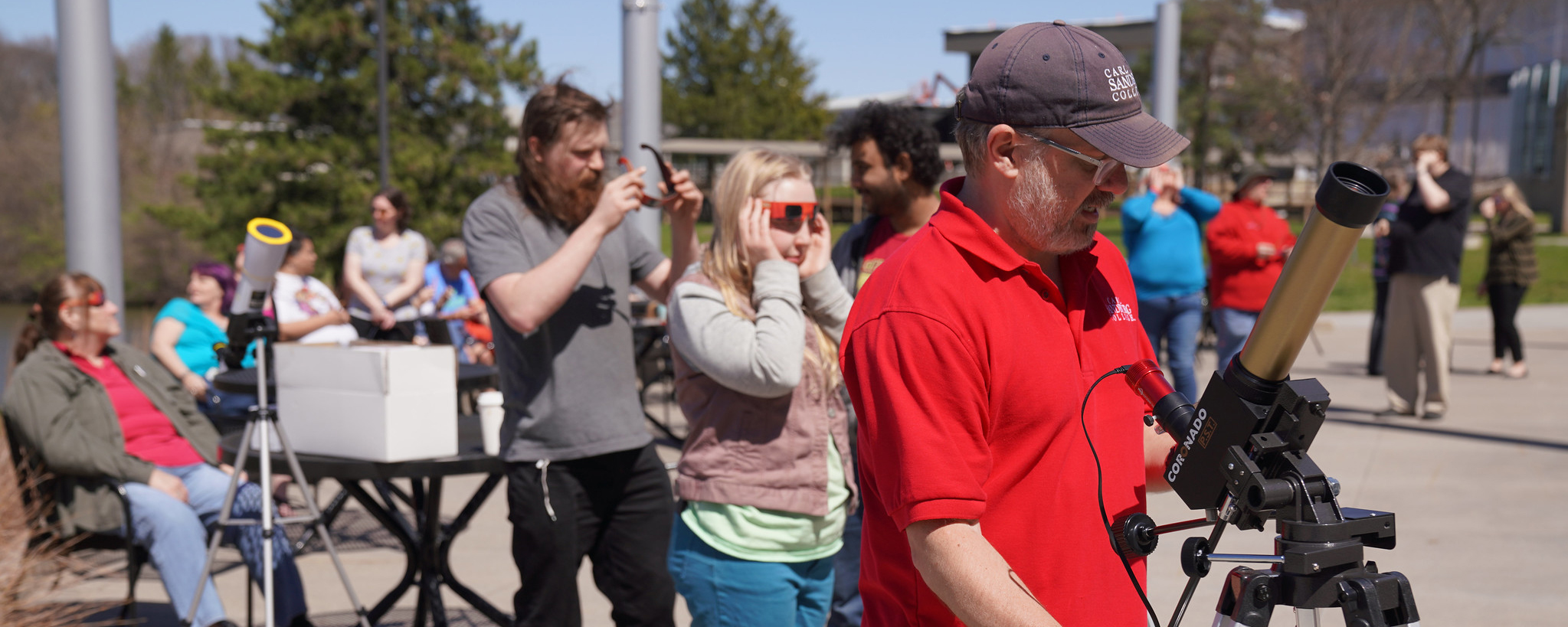 people on patio looking at a solar eclipse