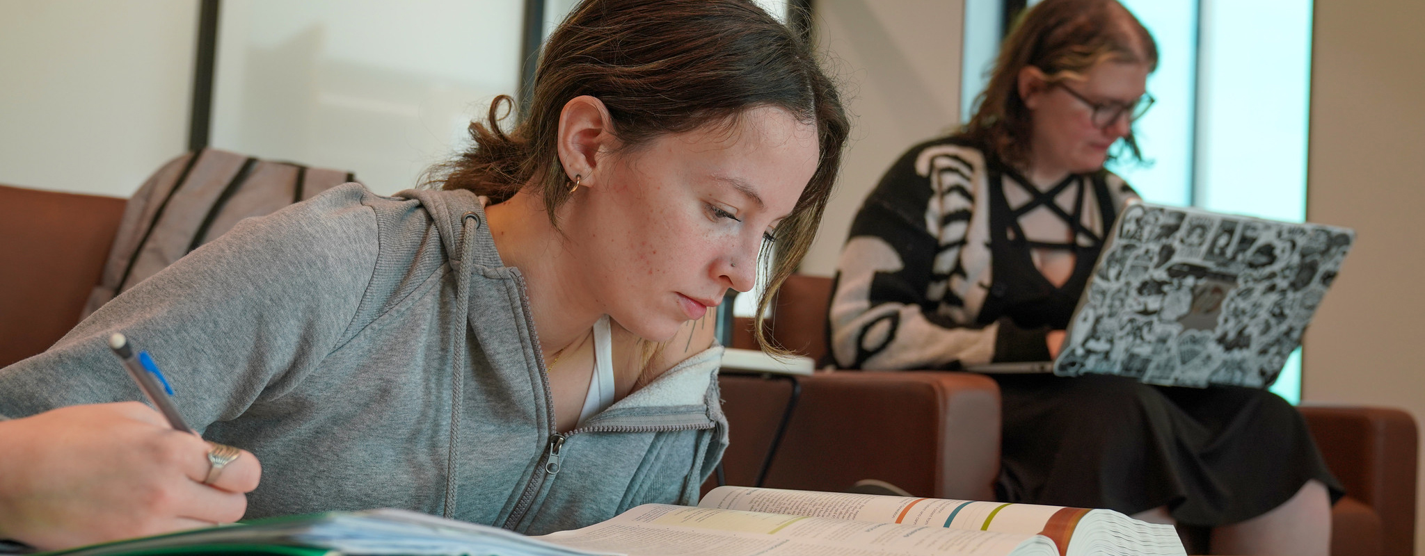 student doing homework in study area.