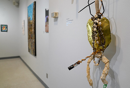 An art piece made of shells hanging on the wall.