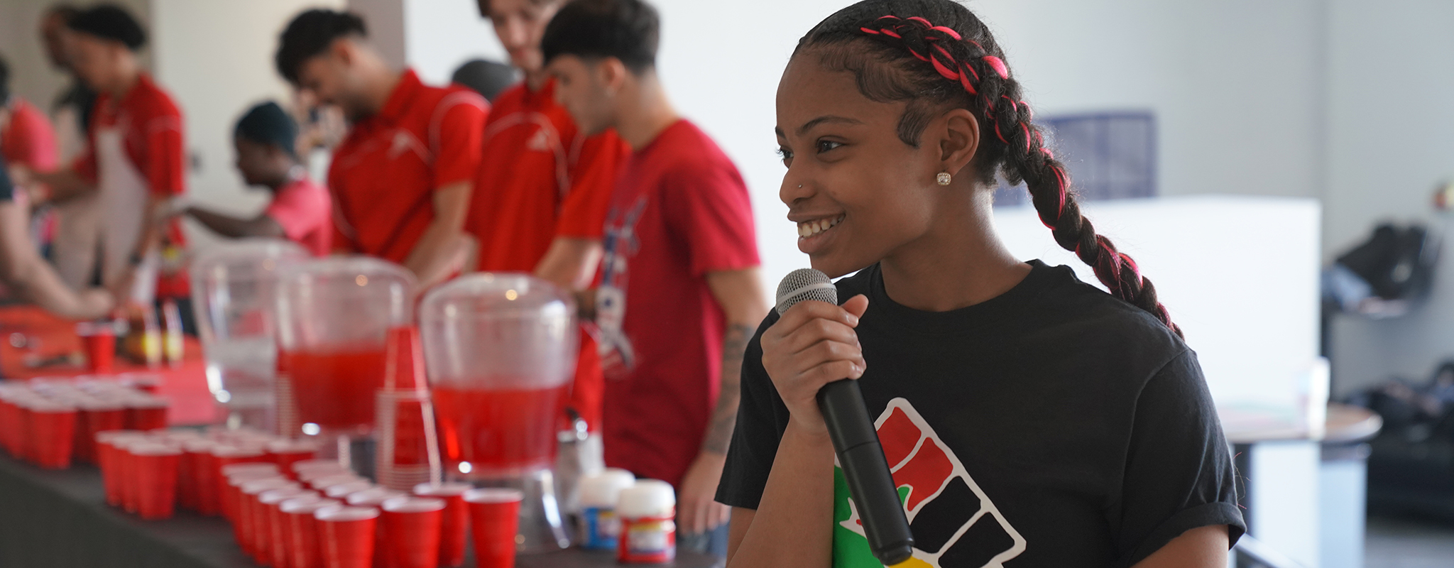 women with microphone smiling.