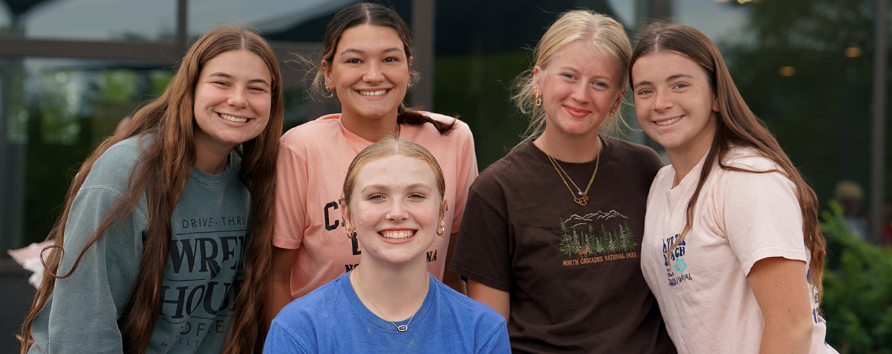 5 female students smiling at the camera.