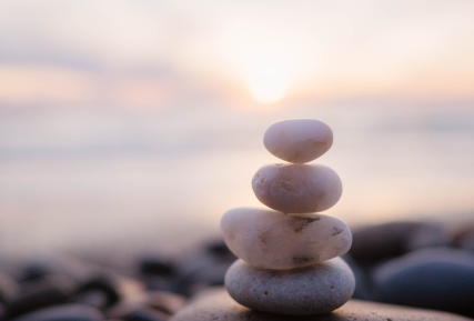 Several rocks stacked on top of each other in the water