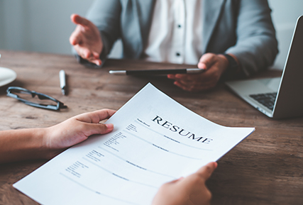 Someone holding a resume