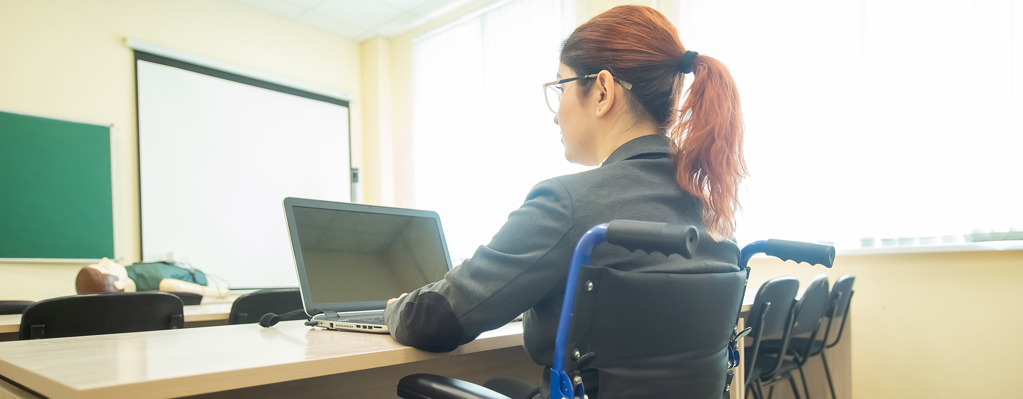 student in wheelchair in a classroom.