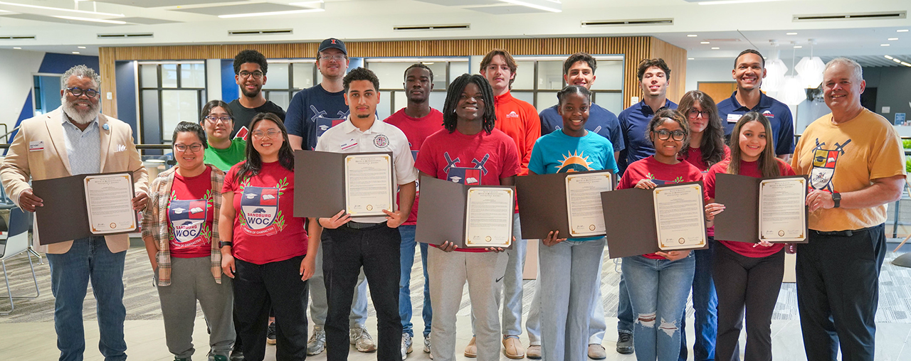 A group of students showing their certificates.